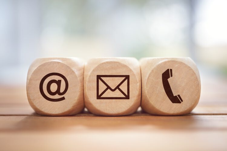 Contact us concept with wood block and symbols Contact us